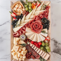 A beautiful charcuterie board with a cheese and meat selection