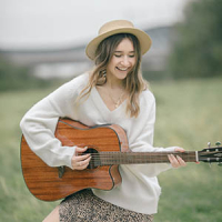 woman playing her guitar