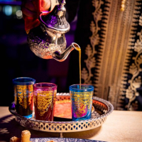 man serving tea from a morroccan style jar