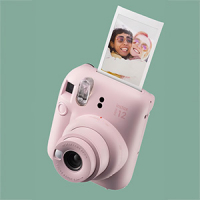 a polaroid camera with a photo coming out